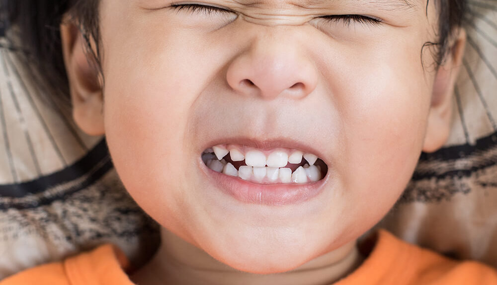 A girl grinds her teeth