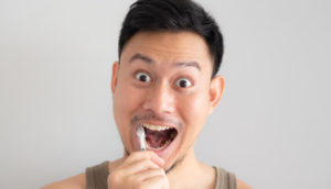 A man brushes his teeth